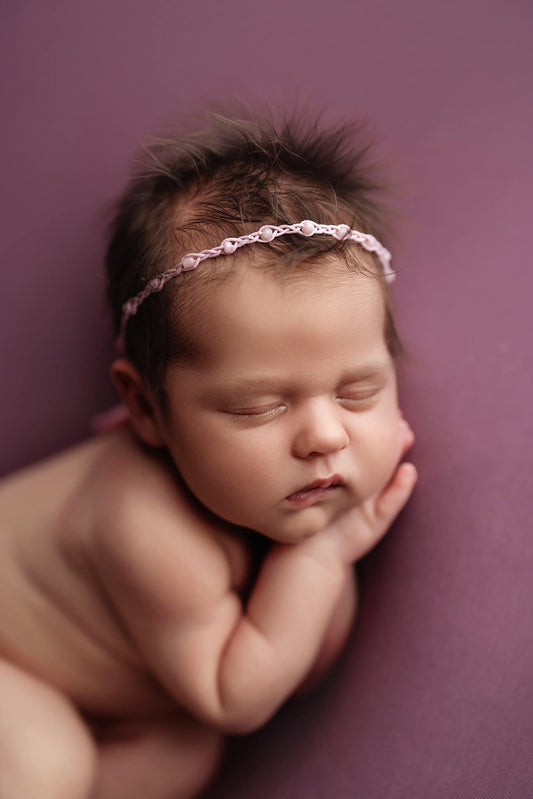 Newborn photography props. Rachel Vanoven photo with braided pink tieback from Little Beans Creations in use.